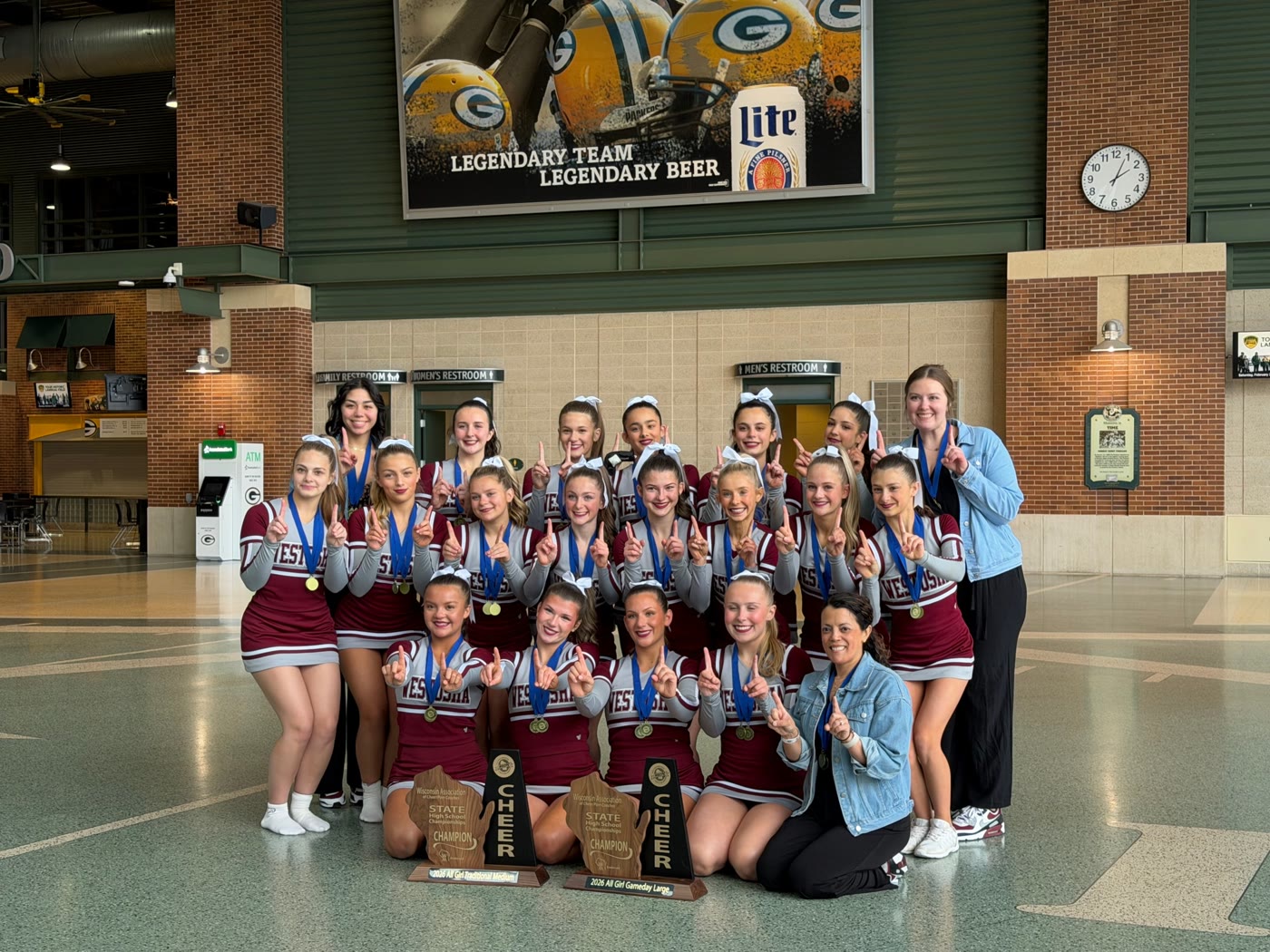 Westosha Central cheer team holding two 2026 state championship trophies